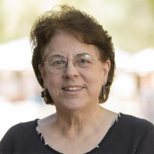 woman with brown hair and glasses